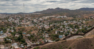 US-Mexico border view from atop a hill on an overcast day
